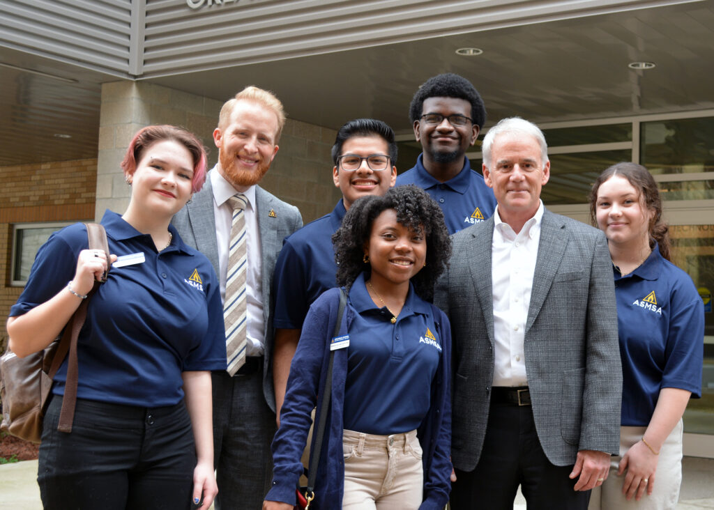 UA System President Jay Silveria poses with ASMSA students and Executive Director Corey Alderdice on campus